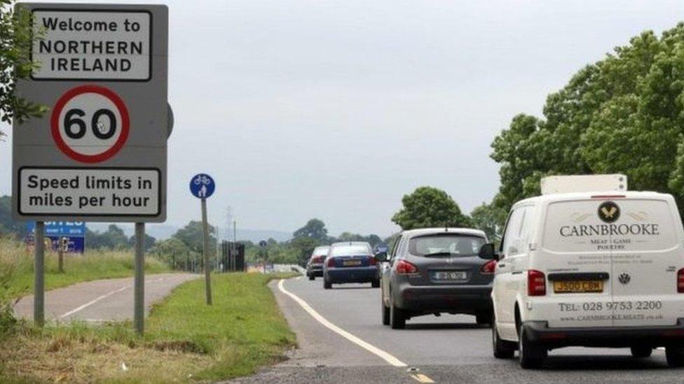 Vehicles travel on a road over the Irish border