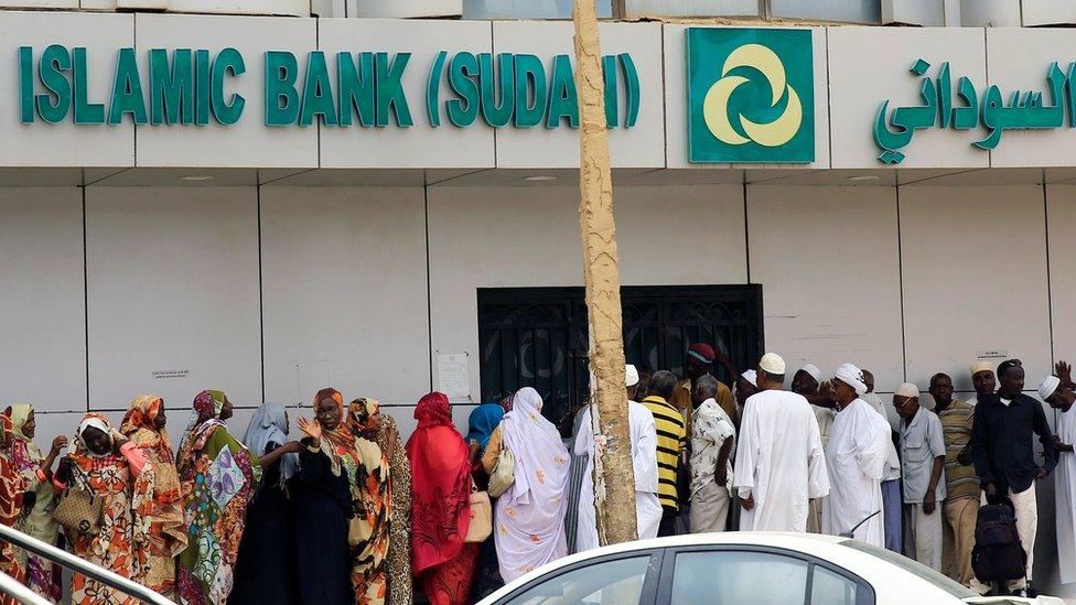 Sudanese customers queue to access money services at the Faisal Islamic Bank (Sudan) in Khartoum, Sudan June 11, 2019.