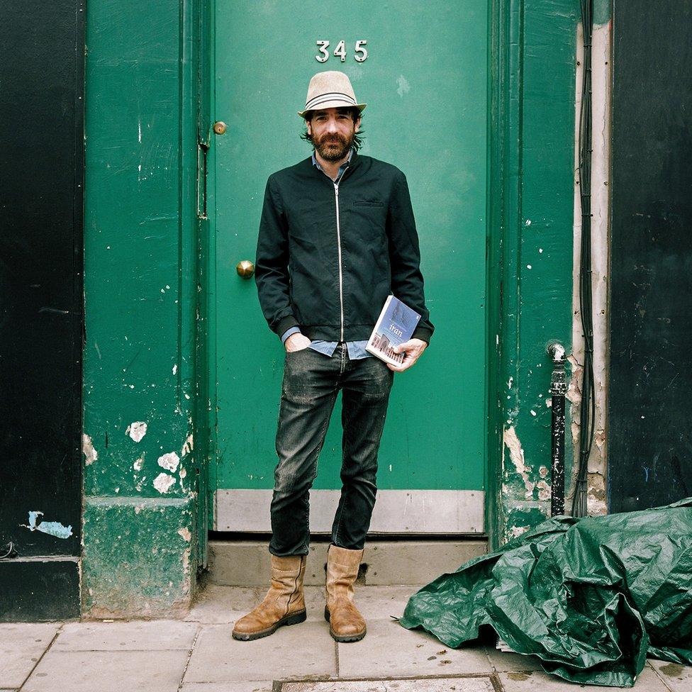 Man in front of a green door