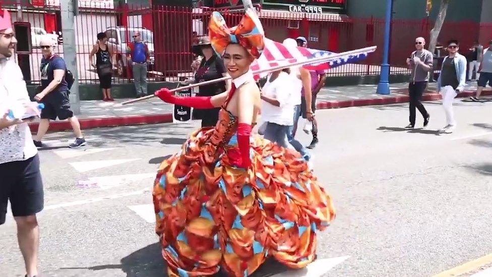 Drag queen waving a US flag