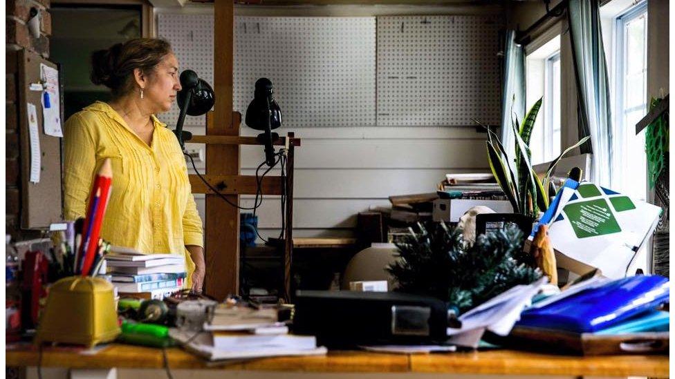 Rosanna Sigue, 59, surveys what was once her personal painting studio after her recent retirement from decades of teaching. "I've never felt such loss. Not even for all of the stuff, but losing my father's voice." Her father, who passed away, was recorded on a device that is now ruined by the flood water. Baton Rouge, La