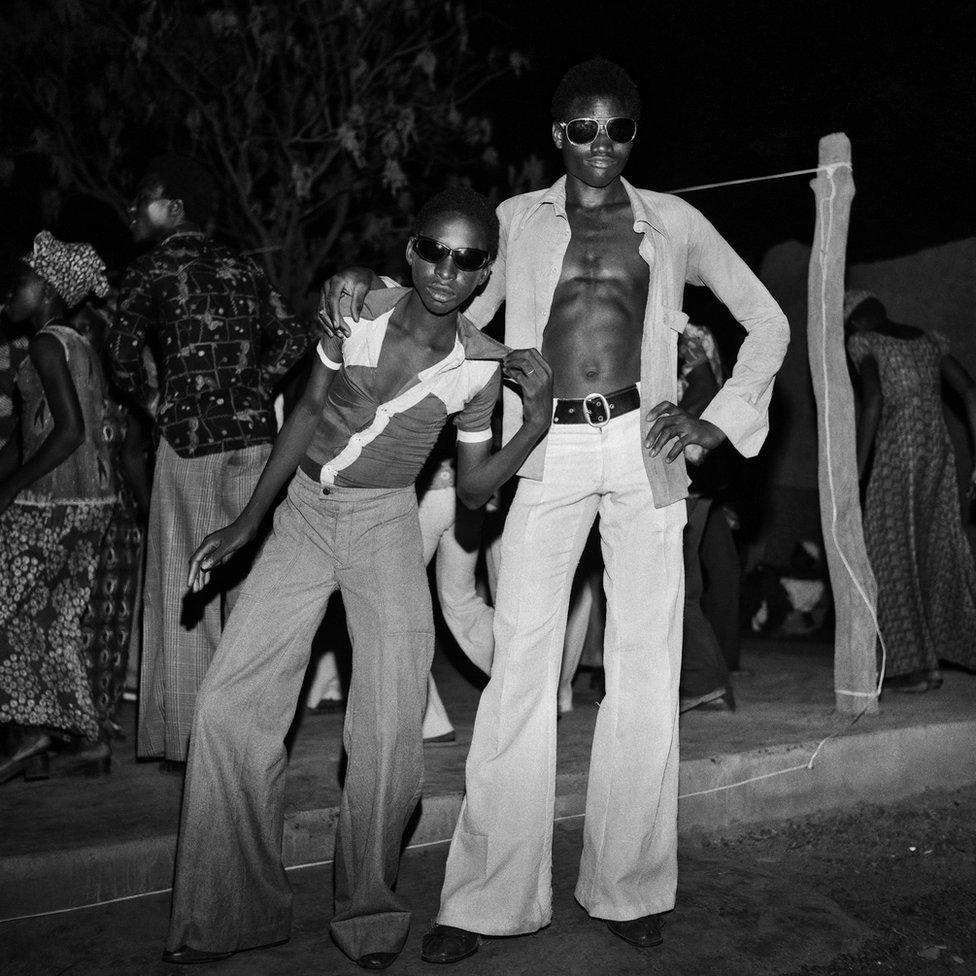 Two men posing in sunglasses