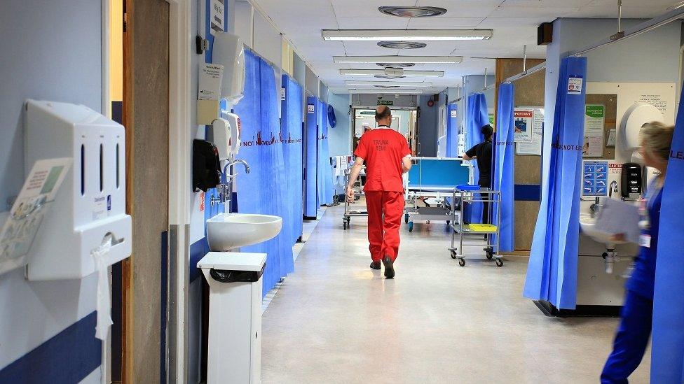 A view of medical worker walking down a hospital ward