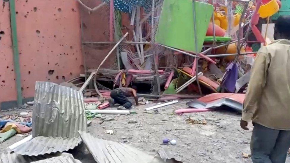 Men inspecting the damaged playground following an air strike in Mekelle, Tigray