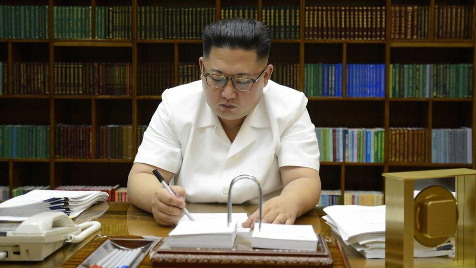 July 27, 2017 picture released from North Korea"s official Korean Central News Agency (KCNA) on July 29, 2017 shows North Korean leader Kim Jong-Un signing documents for test launch of an intercontinental ballistic missile (ICBM)