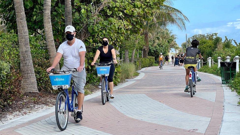 Florida tourists in masks biking