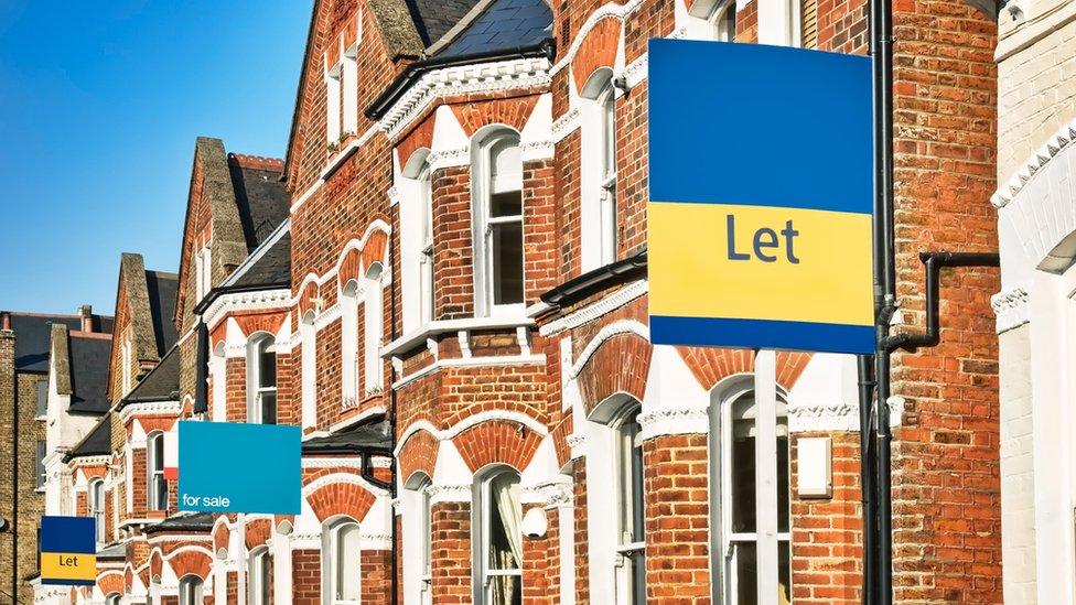 A row of red-brick houses with 'to let' signs