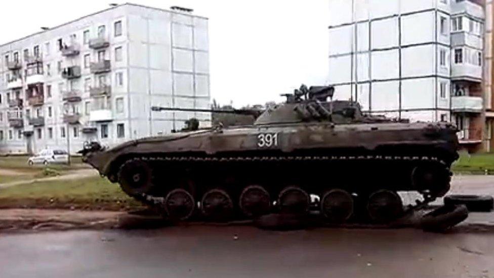 Tank drives over tyres in Zaslonava, Belarus