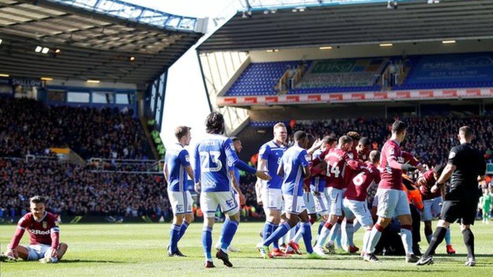 Aston Villa midfielder Jack Grealish sits on the ground following the attack