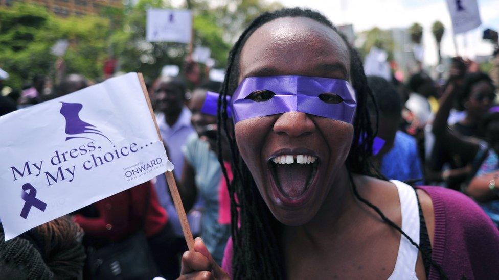 Woman holding a sign saying "My Dress My Choice"