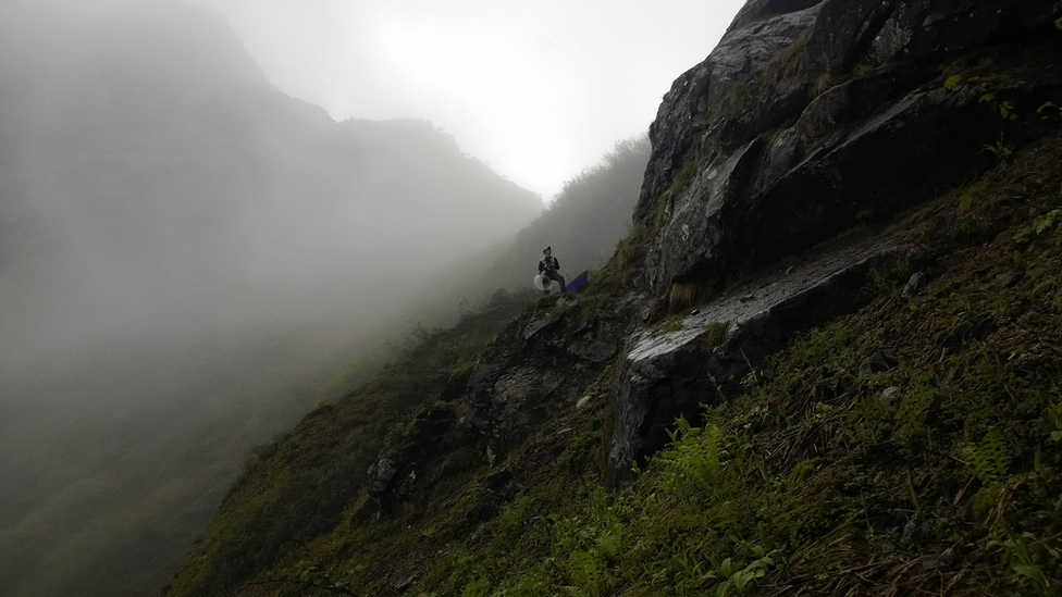 researcher on a steep hillside