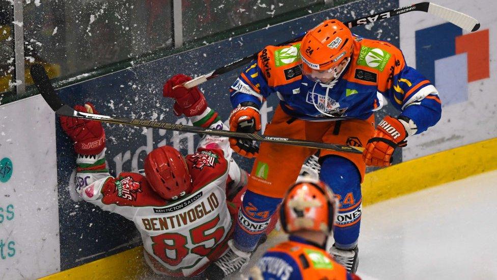 Devils player Sean Bentivoglio (l) hits the ice during the Ice Hockey Elite League Challenge Cup Final between Sheffield Steelers and Cardiff Devils at Ice Arena Wales on March 5, 2017 in Cardiff, Wales.