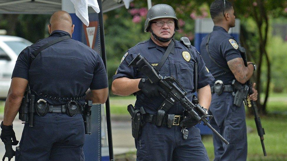 Baton Rouge Police stand at a checkpoint at the entrance of Our Lady Of The Lake Medical Center, Sunday, 17 July 2016, in Baton Rouge,