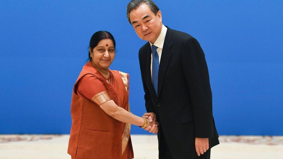 Indian Foreign Minister Sushma Swaraj (L) shakes hands with Chinese Foreign Minister Wang Yi before a meeting of foreign ministers and officials of the Shanghai Cooperation Organisation (SCO) at the Diaoyutai State Guest House in Beijing on April 24, 2018.