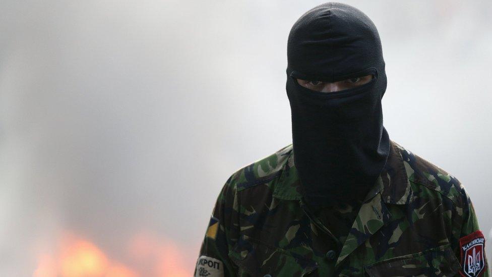 A participant looks on during a rally held by members of the radical group Right Sector, in central Kiev, Ukraine, 3 July 2015.