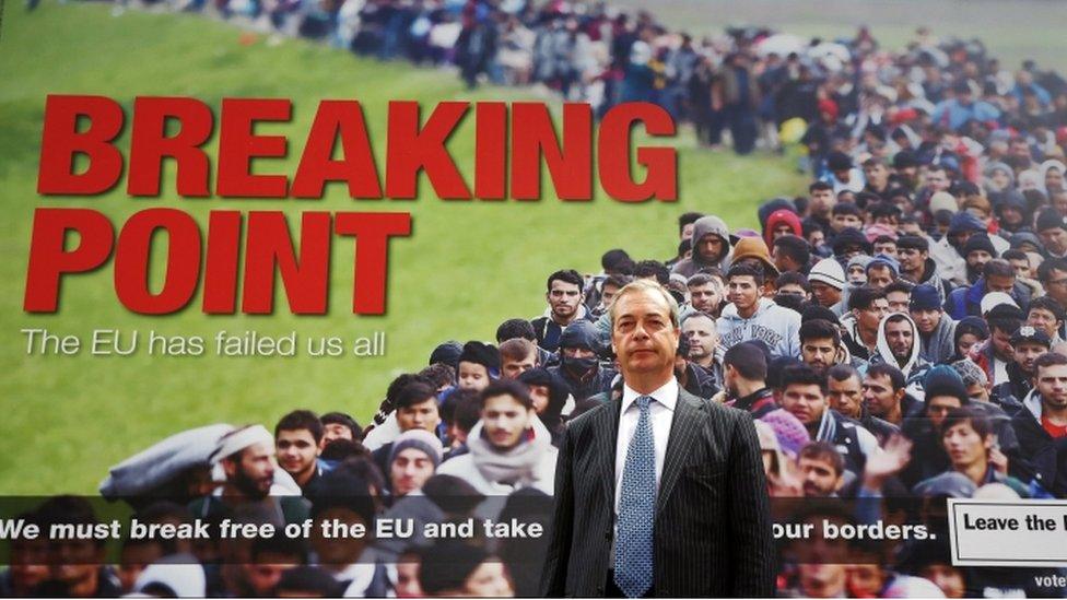 Nigel Farage stands in front of an EU referendum campaign poster