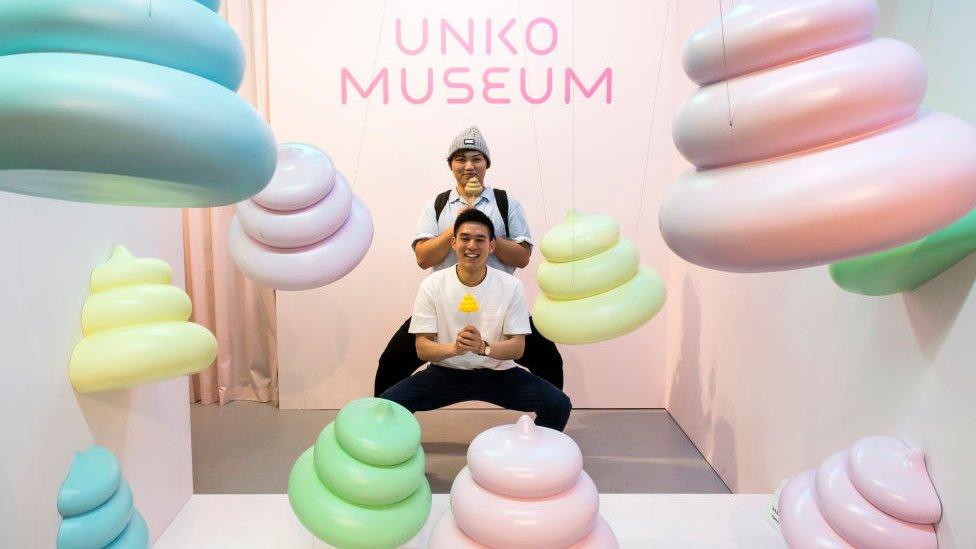 Men-pose-with-lollipop-poos-at-Unko-museum.