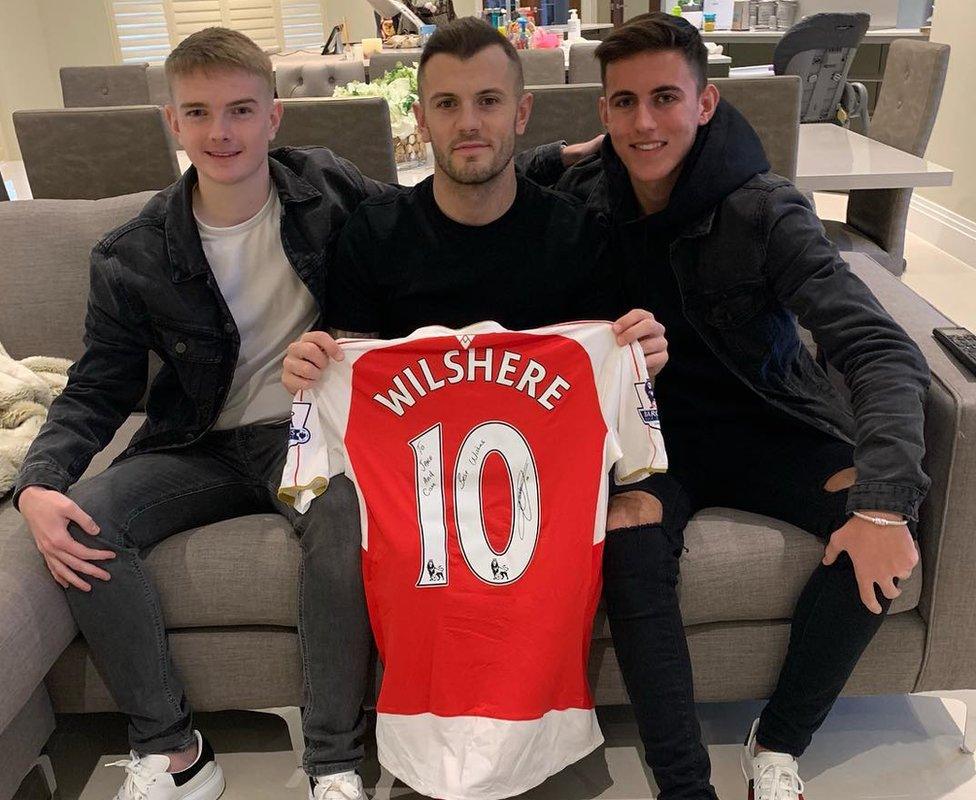 Jake and Cam with Jack Wilshire holding a signed shirt.