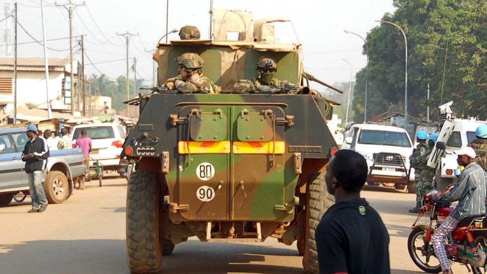 UN peacekeepers patrol in their armoured personnel carriers (APC) along a street during the presidential election in the mainly Muslim PK-5 neighbourhood in Bangui CAR