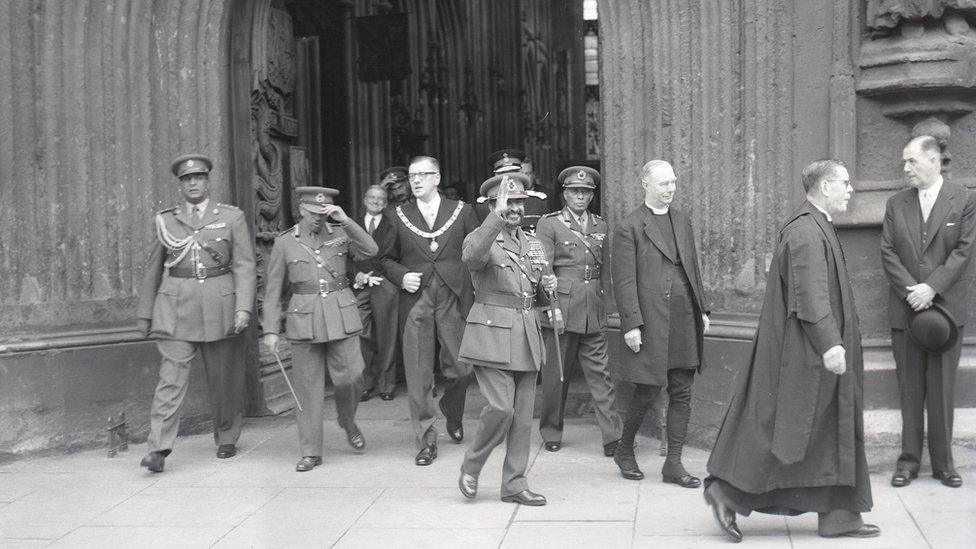 Haile Selassie leaving Bath Abbey to meet crowds, October 1954