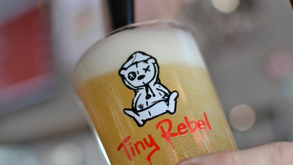 Pint of Tiny Rebel beer being poured