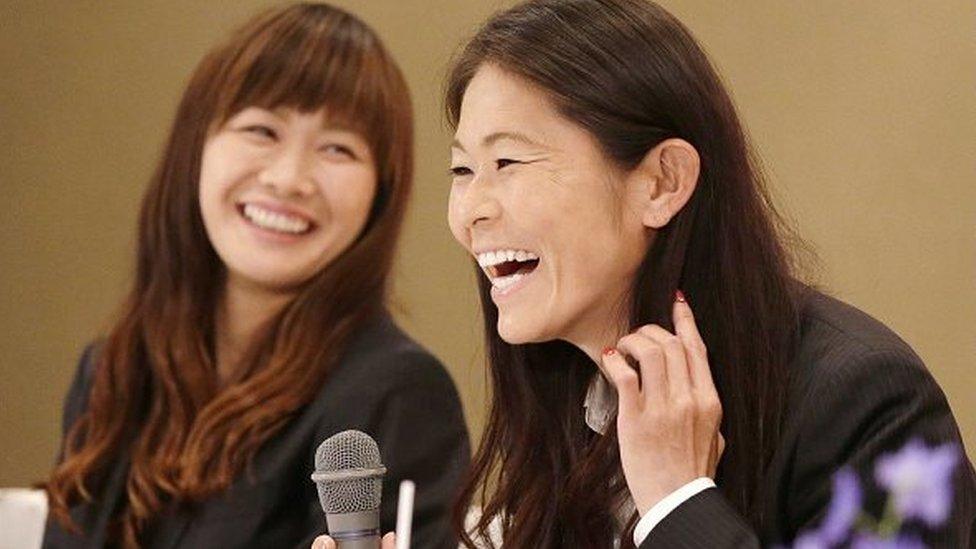 Japan's female football player Homare Sawa (R) smiles with her teammate Nahomi Kawasoe (L) as they were selected to Japan's national team members for the FIFA Women's World Cup at Kobe in Hyogo prefecture, western Japan on May 1, 2015