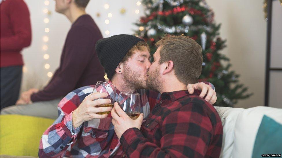 Two men kissing