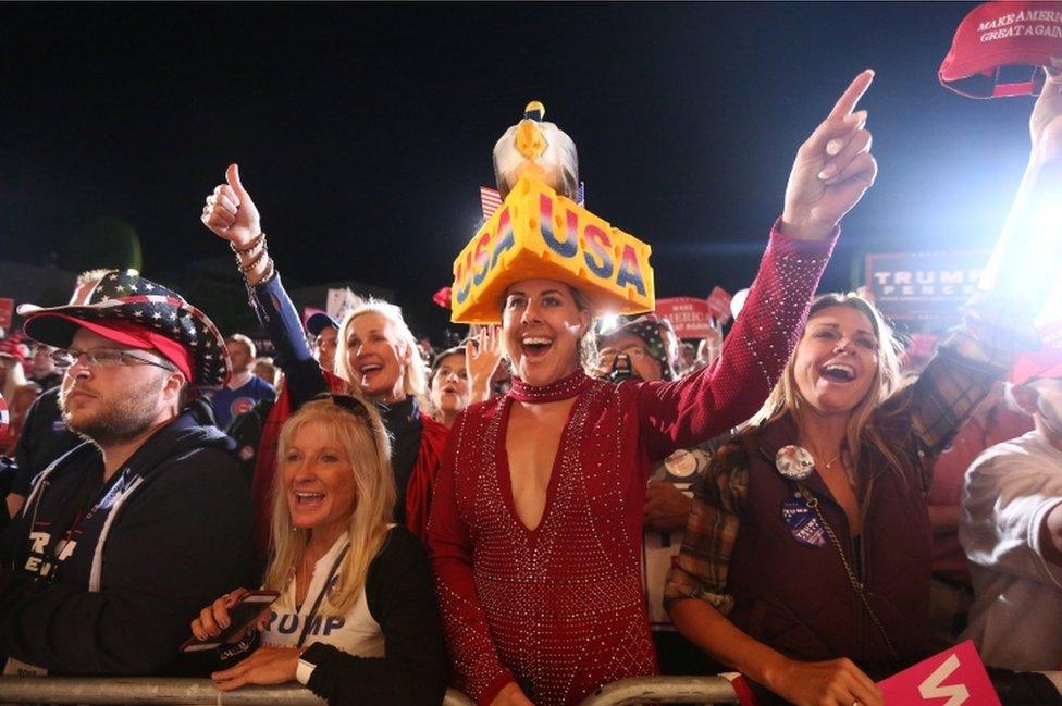 Supporters cheer as Republican presidential nominee Donald Trump speaks at a campaign event in Cedar Rapids, Iowa