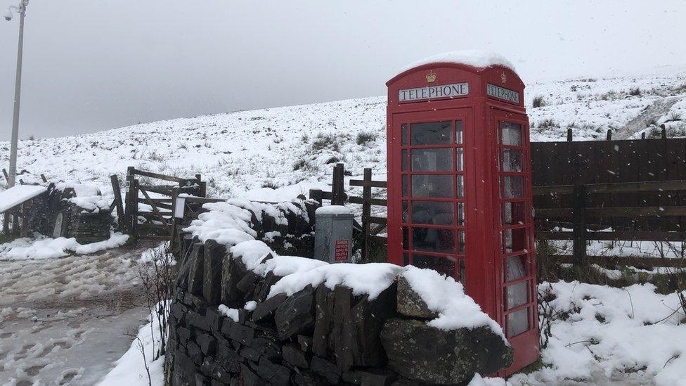 A phone box surrounded by snow in Libanus, Powys