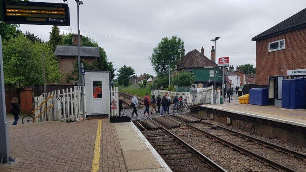 View looking south along platform 1 (not on the day of the incident) showing passenger information screen, crossing attendant’s cabin and footpath crossing