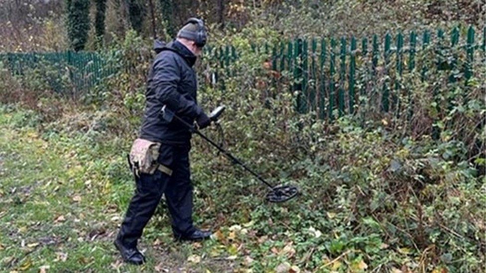 Metal detectorist searching bushes on police operation