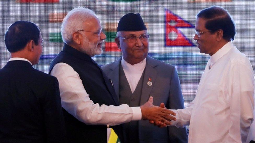 Indian Prime Minister Narendra Modi (second left) shakes hands with Sri Lankan President Maithripala Sirisena (right) in the presence of Nepali Prime Minister Khadga Prasad Sharma Oli