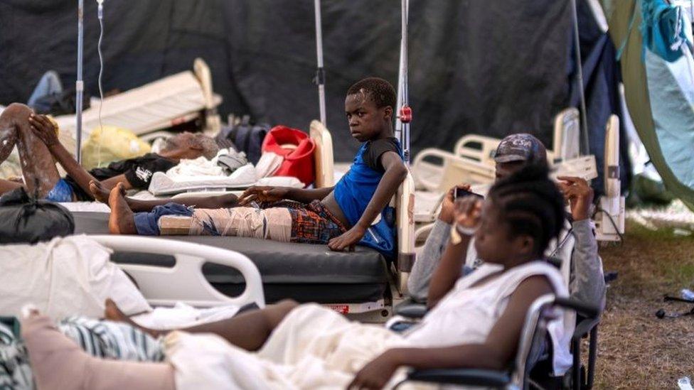 People injured after Saturday's 7.2 magnitude quake are seen on hospital beds under a tent in the Ofatma hospital after it suffered structural damage, in Les Cayes, Haiti August 18, 2021.