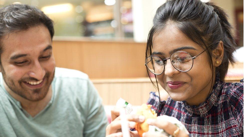 Couple eating burgers