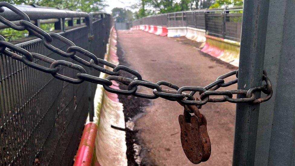 A padlock at the entrance to the cemetery