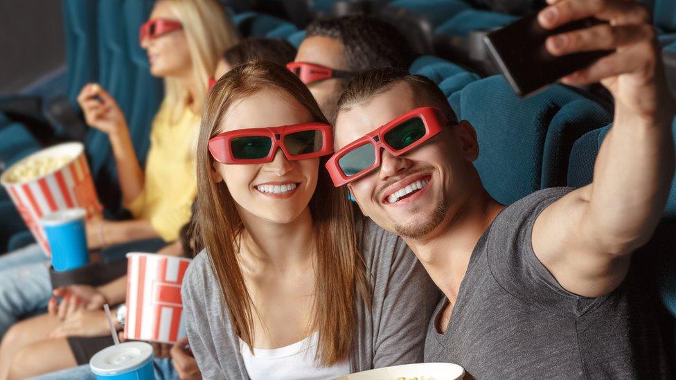 People taking a selfie in the cinema