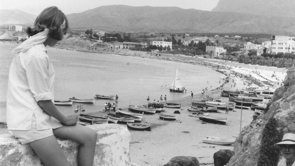 Tourist looks at Benidorm beach in 1963