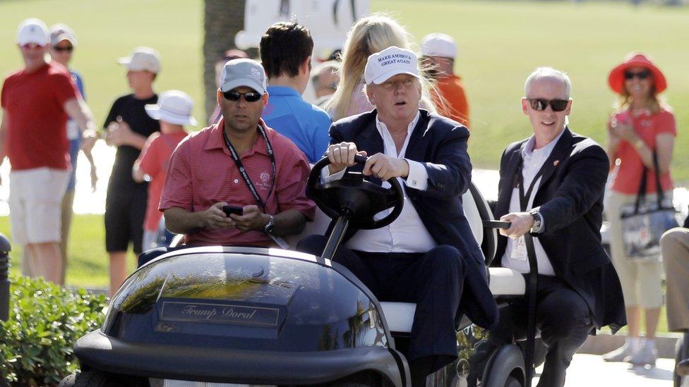 Donald Trump drives himself around his Doral golf course