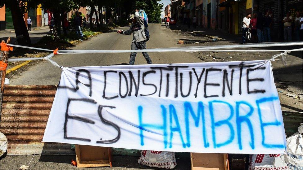 A banner placed by anti-government activists against President Nicolas Maduro's Constituent Assembly reading 'The Constituent Means Hunger,' is seen in Caracas' Petare neighbourhood on July 26, 2017.