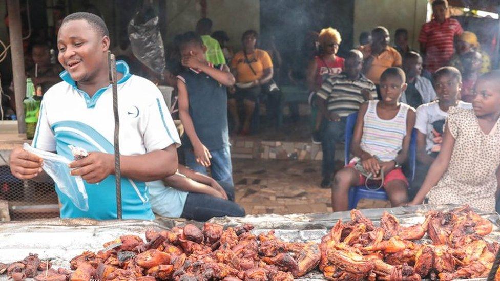 Man selling chicken in a street of Arondizuogu during the Ikeji Festival in Nigeria