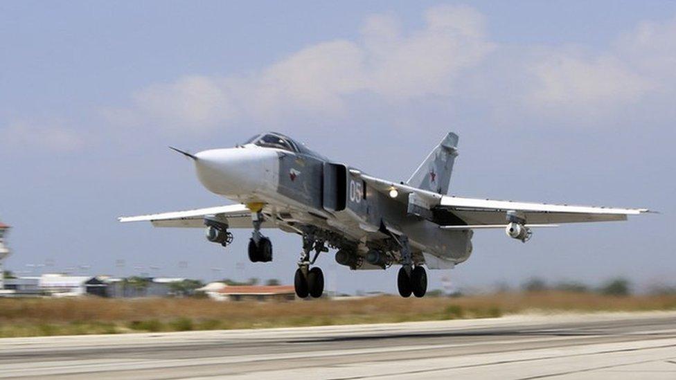 A Russian SU-24M jet fighter armed with laser guided bombs takes off from a runaway at Hmeimim airbase in Syria