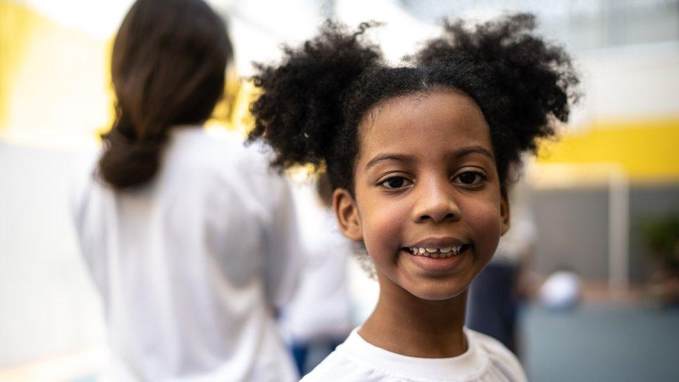 Girl with afro hair in school playground