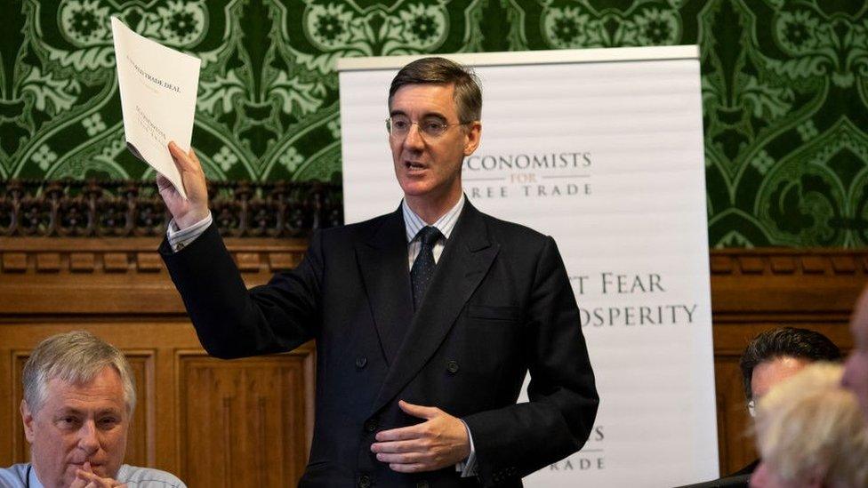 Jacob Rees-Mogg holding the report