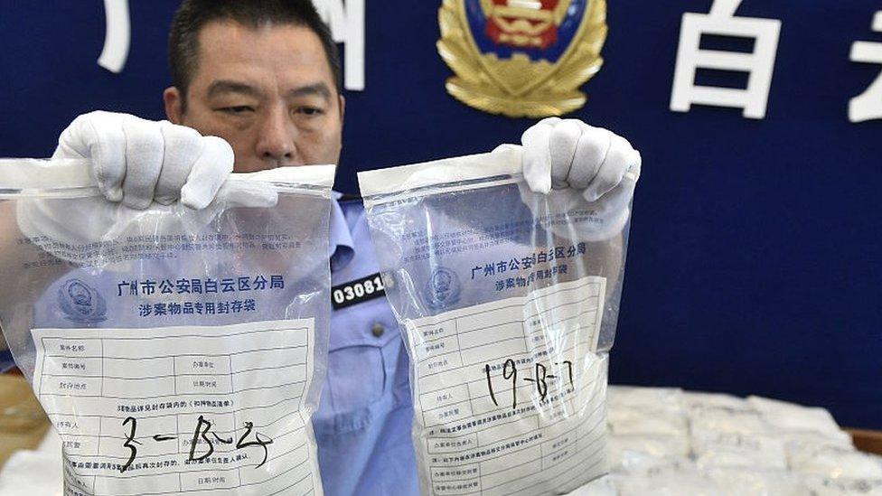 The police officer shows the seized crystal meth on May 18, 2016 in Guangzhou, Guangdong Province of China.