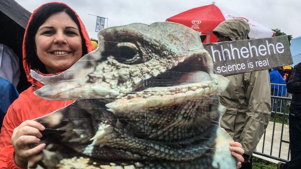 Woman carrying poster reading Science Is Real