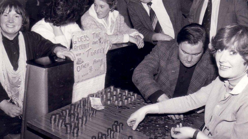 Parents collecting in a Christmas raffle to raise funds for the school in 1981