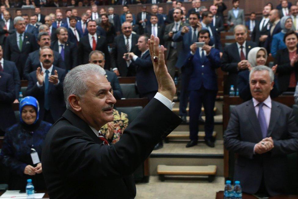 Turkish Prime Minister Binali Yildirim waves at a meeting of AKP MPs in Ankara, 8 November