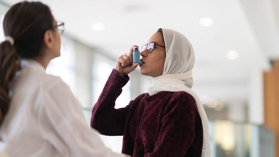 A woman with an inhaler