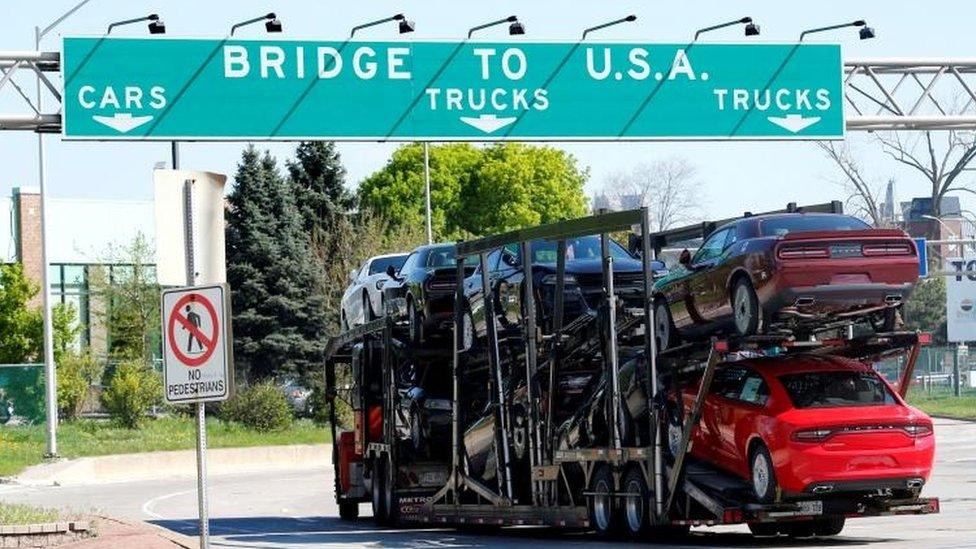 Car transporter heading for Detroit, Michigan, drives on the lane to Ambassador Bridge in Windsor, Ontario, Canada