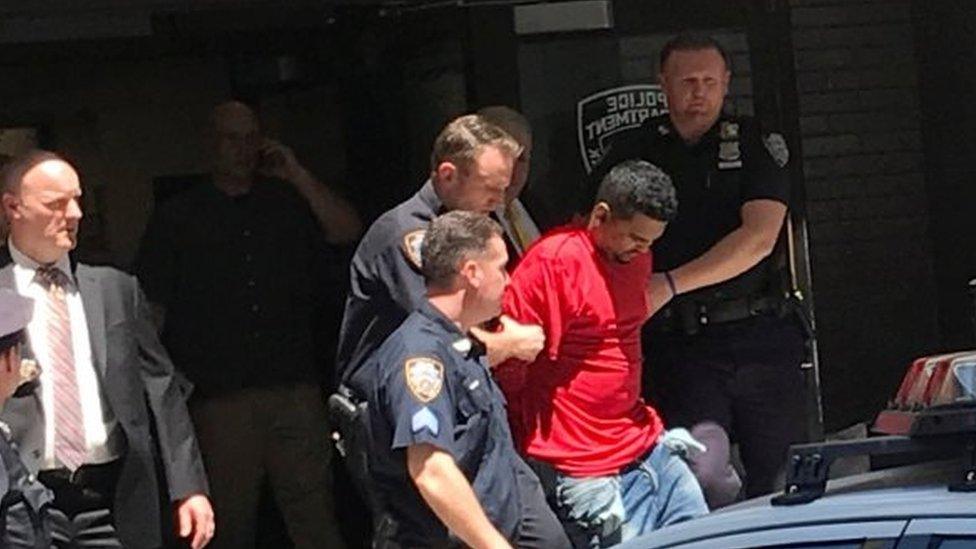 A man who police said was the suspected driver of a car which crashed into a crowd on Times Square, is led out of the NYPD office in New York.